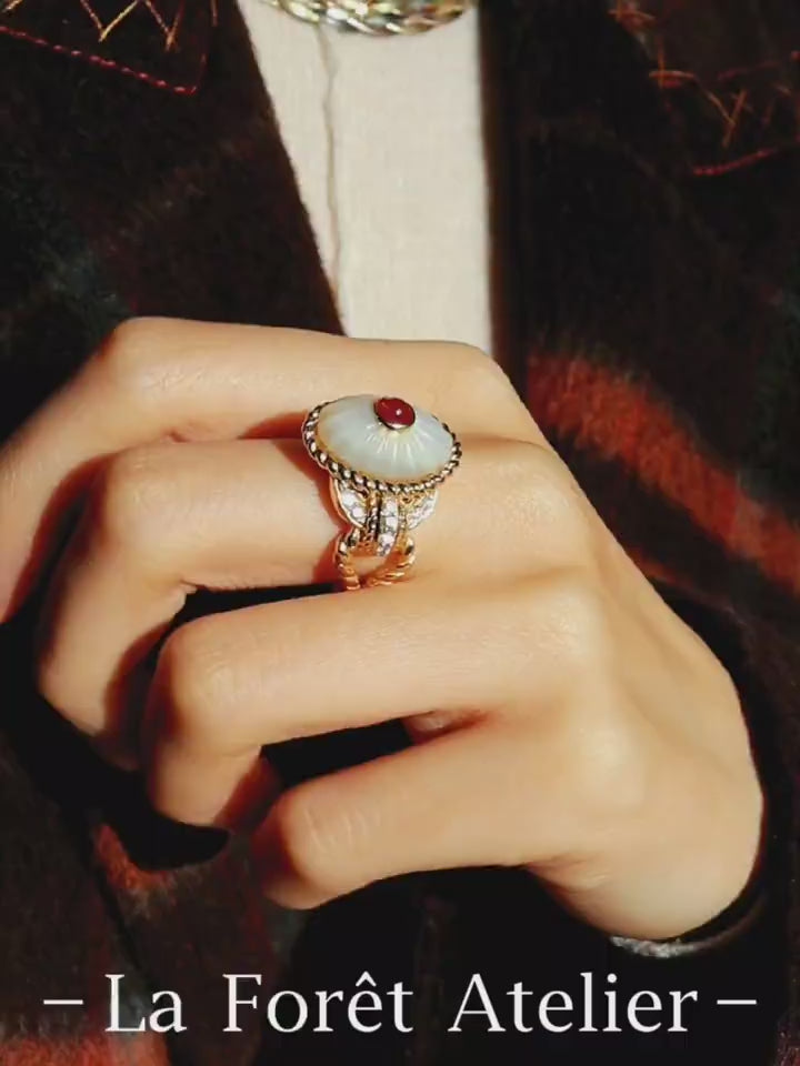 Statement ring with lab-grown ruby and carved mother-of-pearl dome with gold and diamond accents








