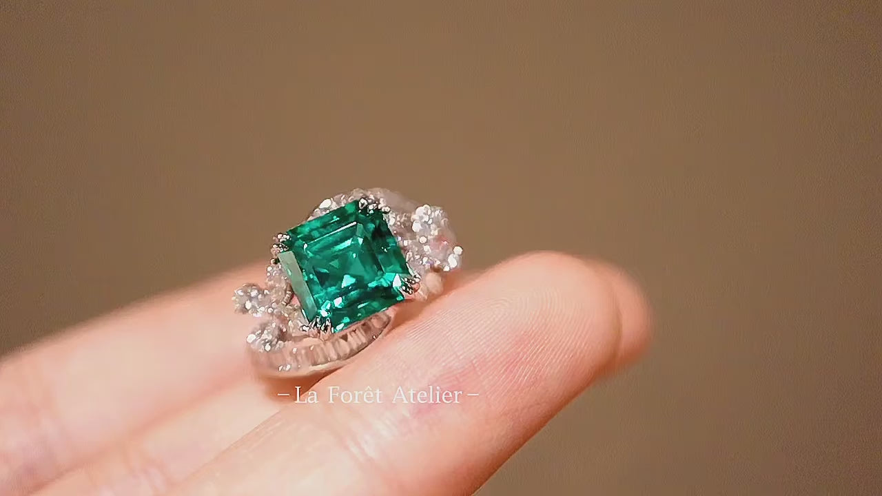 Lab emerald statement ring with white gold floral design

