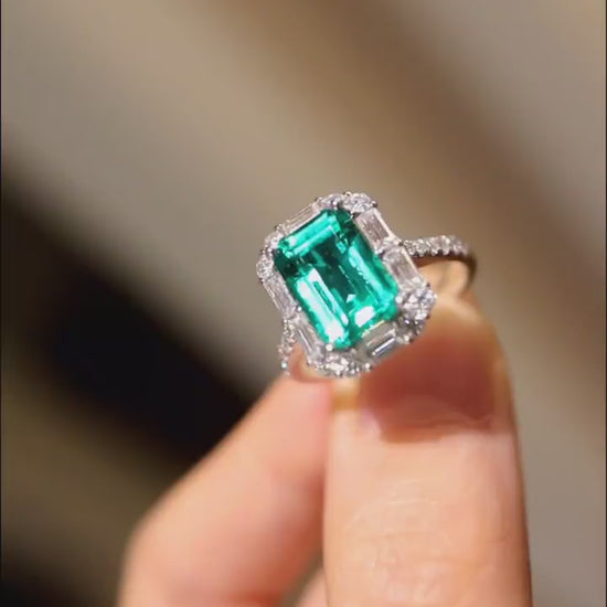 Radiant 3ct emerald-cut lab-grown emerald ring with halo diamonds in white gold








