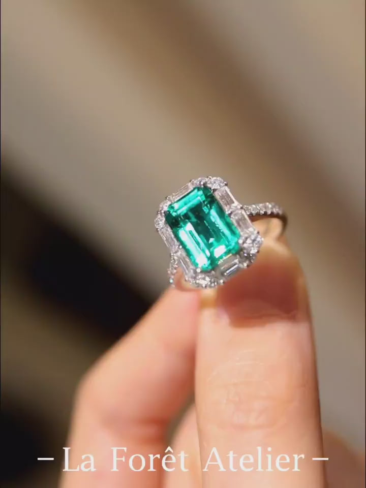 Radiant 3ct emerald-cut lab-grown emerald ring with halo diamonds in white gold








