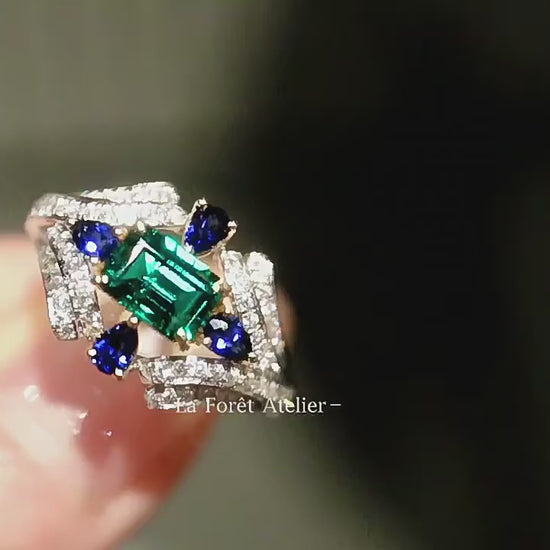 Baguette-cut lab emerald ring with pear-shaped sapphires


