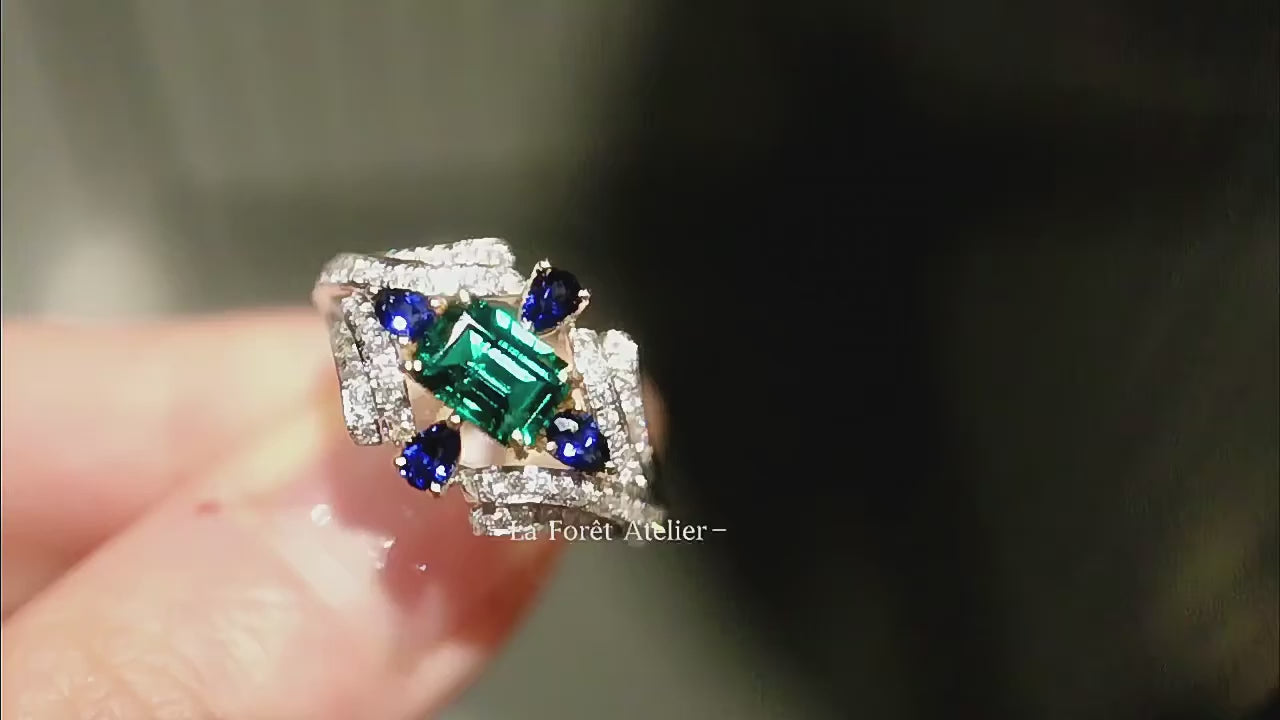Baguette-cut lab emerald ring with pear-shaped sapphires

