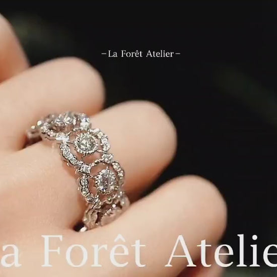 Eternity band ring with lab-grown diamonds and tourmalines in circular halo setting








