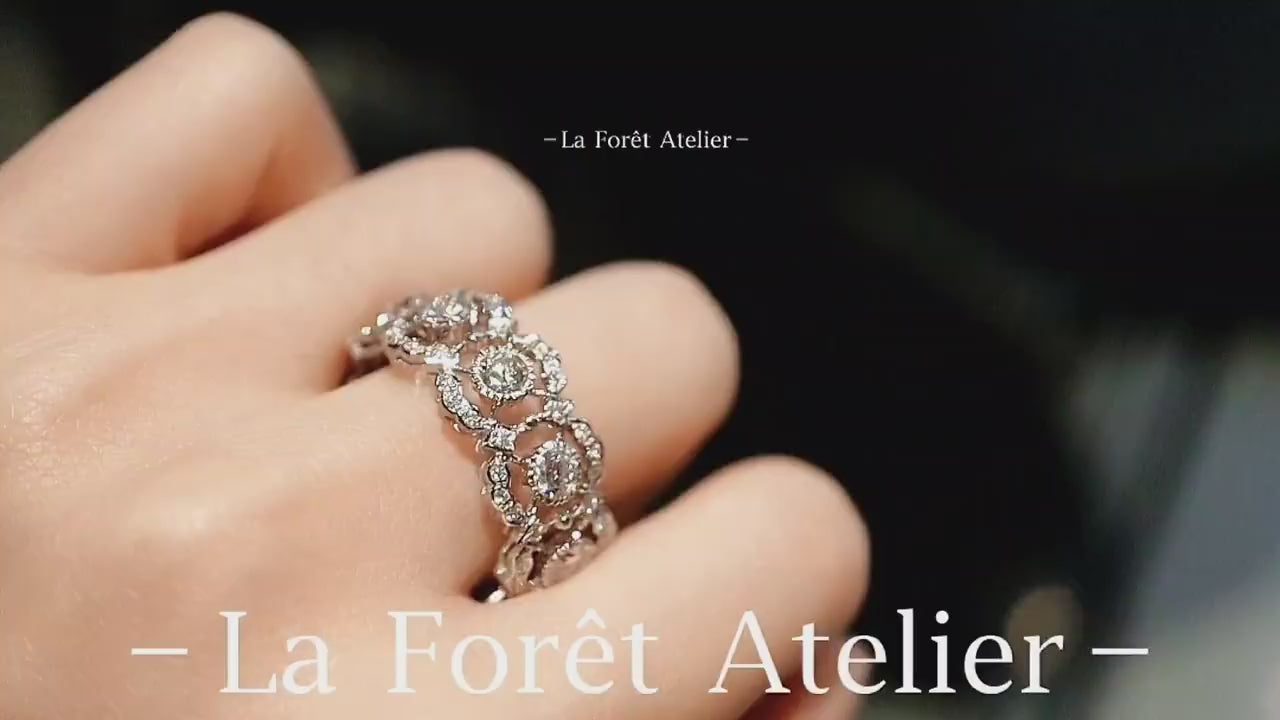 Eternity band ring with lab-grown diamonds and tourmalines in circular halo setting








